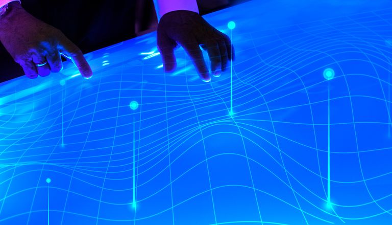man-touching-the-futuristic-blue-screen-3RXLAAK